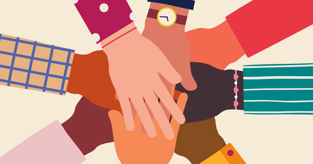 eight hands touching in show of unity and teamwork